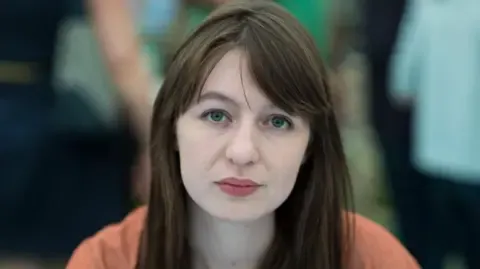 Irish author Sally Rooney claims she is unable to enter the UK due to potential arrest